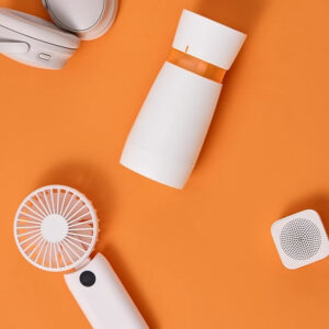 Modern tech accessories enhancing convenience and style for everyday use in vibrant orange backdrop.