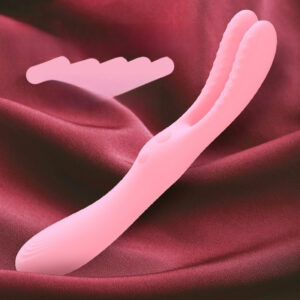 Dual-ended pink silicone vibrator on rich red fabric, perfect for sensual pleasure and exploration.