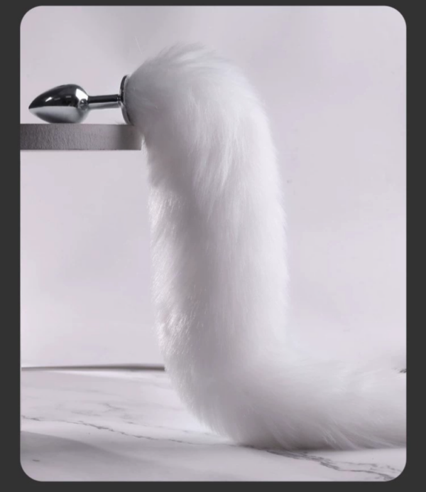 Sleek metallic design with fluffy tail, perfect for playful luxury in intimate moments.