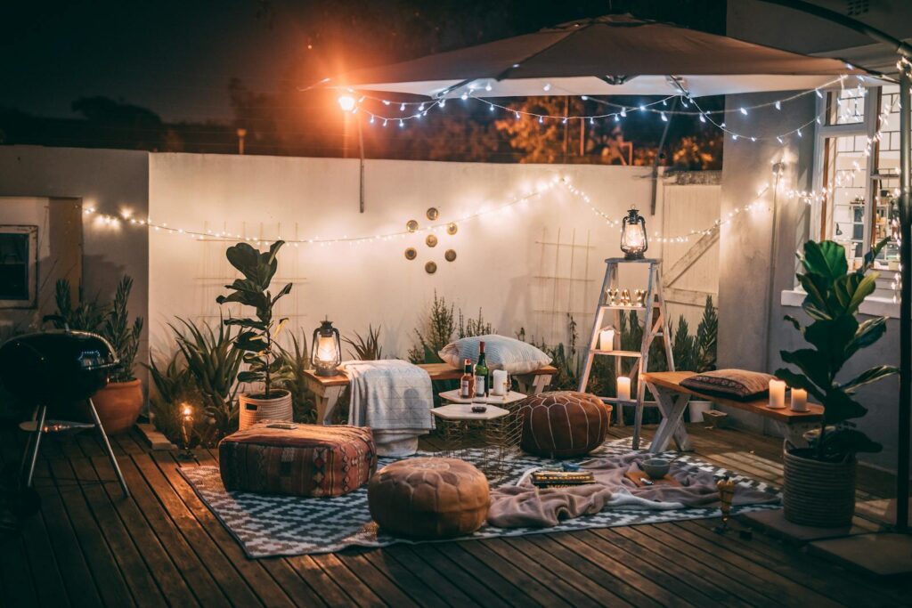 Inviting outdoor patio setup at night featuring cozy seating, string lights, and decor for perfect relaxation.