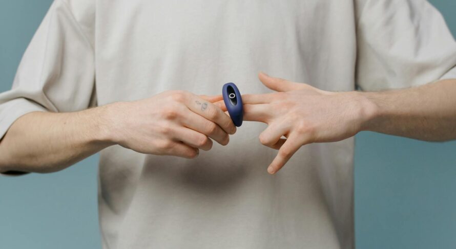 Man demonstrating a personal wellness device, focusing on body care and self-love.