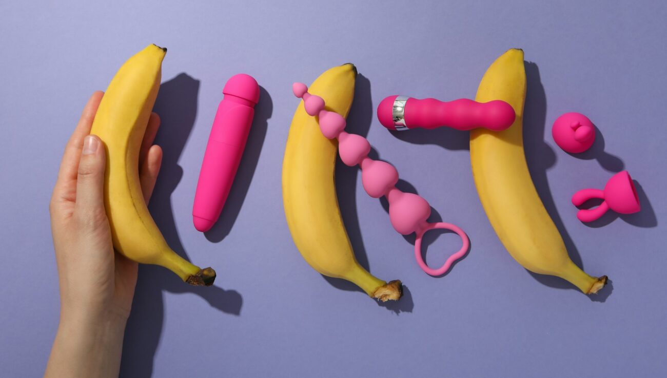 A collection of sex toys on a purple background.