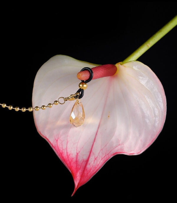 Elegant anthurium flower with sparkling jewelry, showcasing beauty and sensuality in floral art.