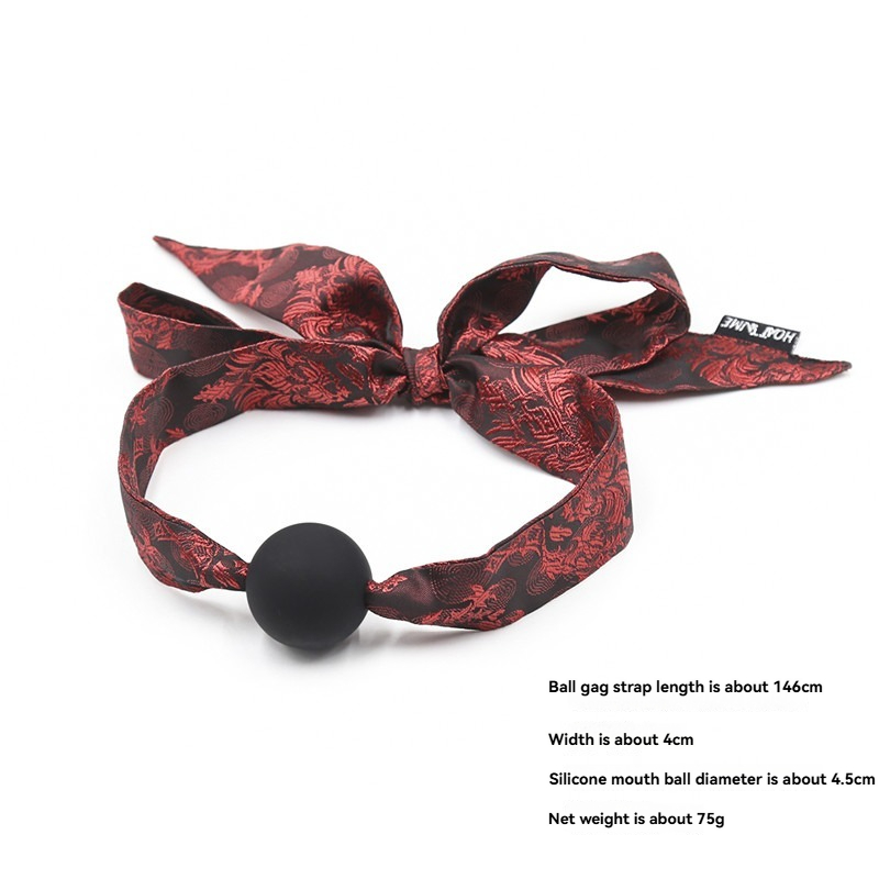 Stylish red satin ball gag with a black silicone ball for BDSM pleasure and restraint.