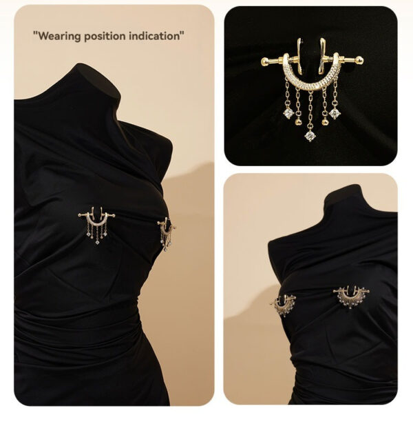 Elegant black dress with gold brooches, perfect for formal occasions and stylish outings.