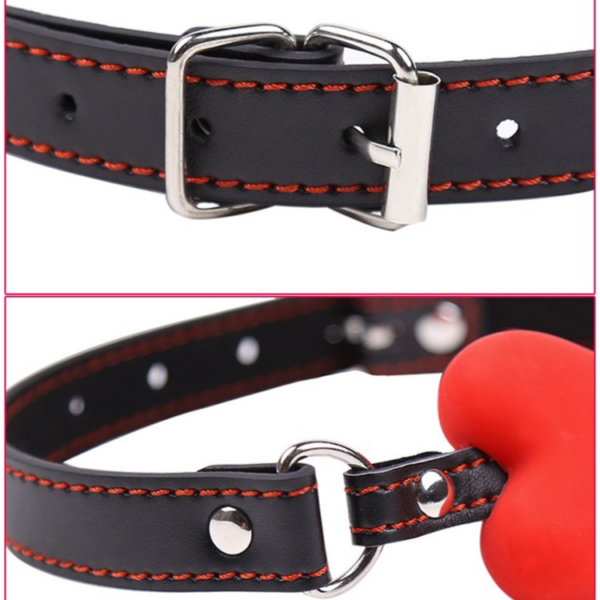 Stylish black leather collar with orange stitching and playful red heart ornament for edgy fashion.