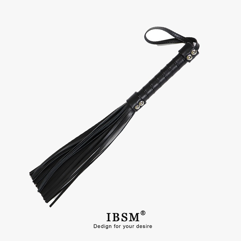 Elegant black leather riding crop with textured handle and flowing tails for BDSM exploration.