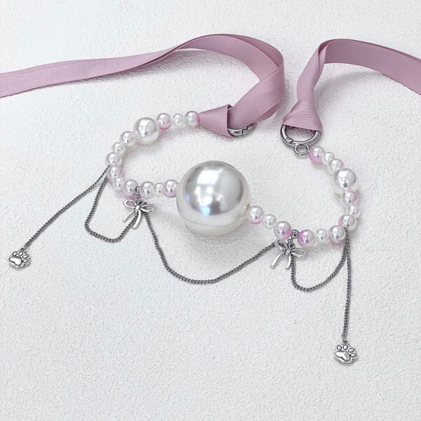 Elegant pearl necklace with charms, perfect for adding whimsy to any outfit.