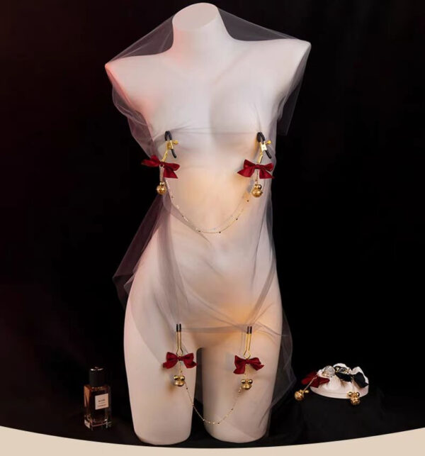 Stylish mannequin draped in tulle, adorned with red bows and golden bells for a whimsical allure.