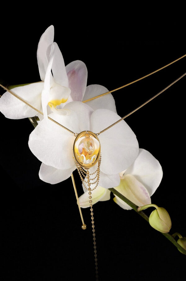 Elegant gold necklace with orchid design, perfect for showcasing natural beauty and luxury.