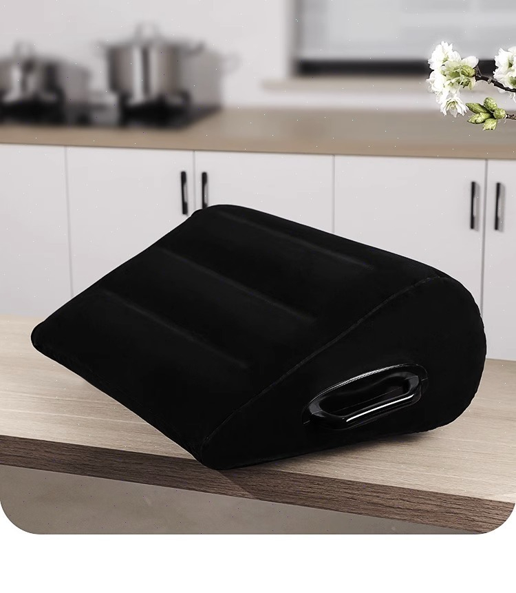 Sleek black wedge pillow for ergonomic support in a modern kitchen setting.