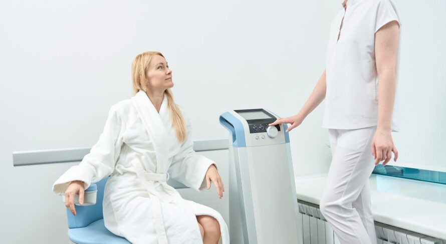 Medical worker checking wellbeing of woman who taking pelvic muscles therapy