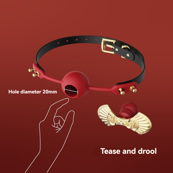 Red ball gag with gold studs and adjustable strap for bondage enthusiasts.