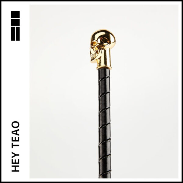 Elegant skull cane with gold handle, perfect for stylish mobility and unique accessory enthusiasts.