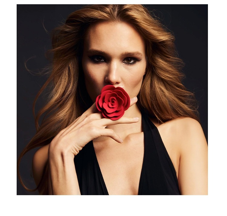 Confident woman with red rose, showcasing beauty and allure in fashion photography.