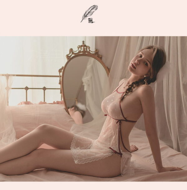 Intimate bedroom scene with a graceful woman in sheer lingerie, reflecting romance and allure.