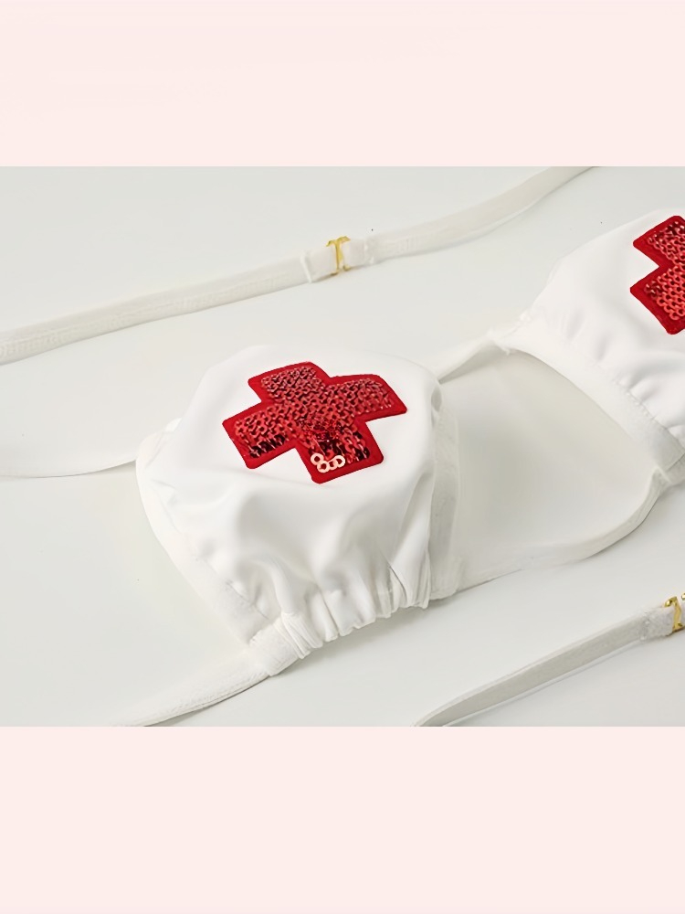 White bikini top with red cross details for trendy summer beachwear and pool parties.