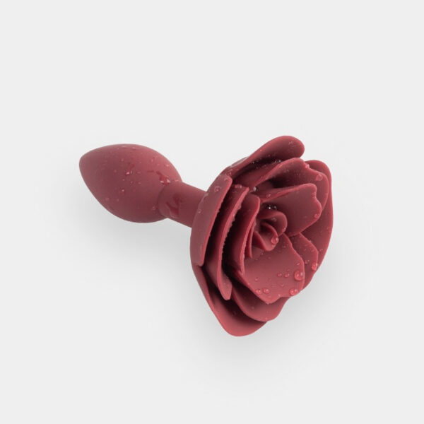 Deep red rose-shaped silicone pleasure device, combining beauty and functionality for intimate experiences.